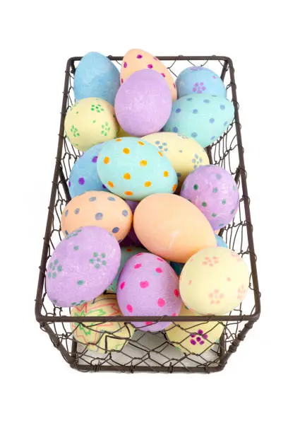 Cut out of painted easter eggs in a chicken wire tray