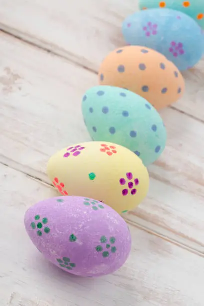Hand-painted pasted easter eggs on a wooden background
