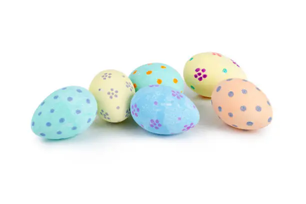 Hand-painted pastel-colored easter eggs over white background