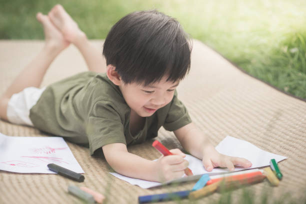 istock child drawing picture with crayon 656122578