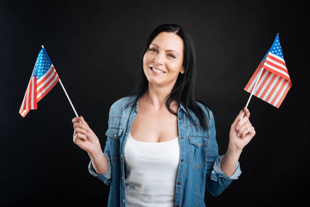 istock Happy looking girl holding American flags 656123230