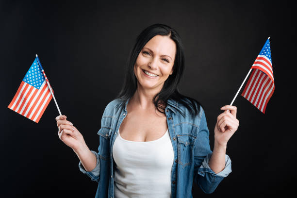 istock Happy attractive female posing with American flags 656123332