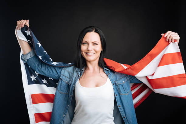 istock Happy woman posing with American flag 656123408