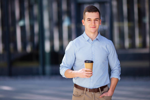 istock Businessman holding his coffee or tea drink on blur background 656123422