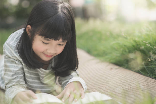 istock Happy asian girl reading a book 656123506