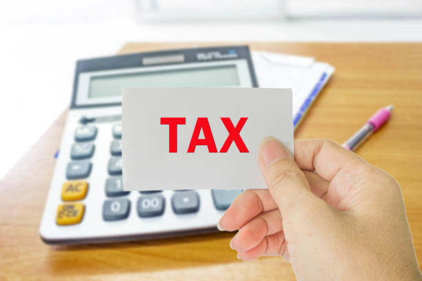 istock hand hold card with word tax 656123772