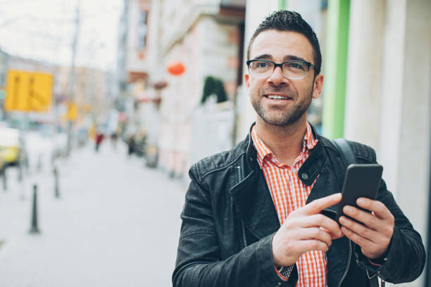 istock Man with smart phone on the street 656124102
