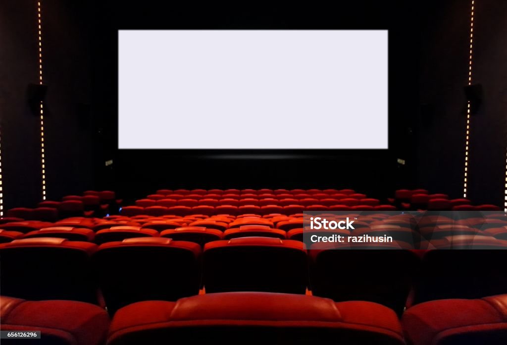 Empty cinema seats with blank white screen Interior view of empty movie seat and blank cinema screen Movie Theater Stock Photo