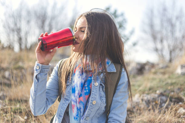 istock Modern woman in nature drinking water 656128954