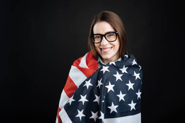 istock Pretty young woman covering herself with flag 656129384
