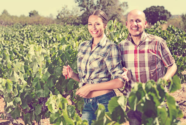 istock man and woman gardeners in grapes tree yard 656131076