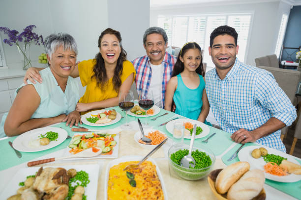 istock Happy multi generation family having meal on table at home 656135540
