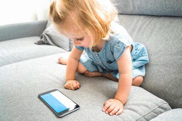 istock little kid playing with the smartphone 656136158