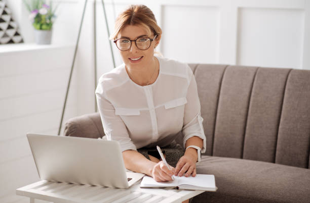 istock Delighted self employed woman writing in her notebook 656137028