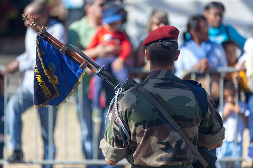 Saint Denis, La Réunion - July 14 2016: Adjutant from the 2e RPIMa (régiment parachutiste d’infanterie de Marine) parading with the flag of his regiment during Bastille Day.