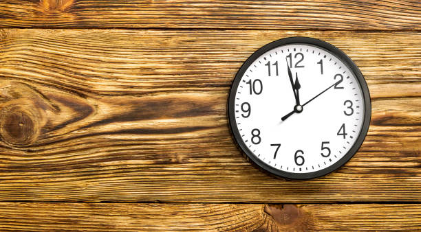 istock Black clock on wooden background. Top view. 656137716