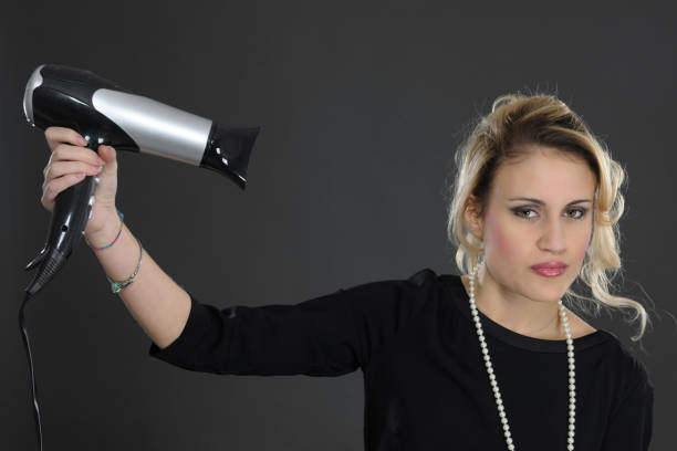 Young girl with hair dryer - fotografia de stock
