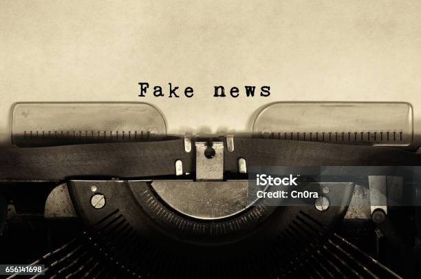 Fake News Words Typed On Vintage Typewriter Stock Photo - Download Image Now - Fake News, Newspaper, Old-fashioned