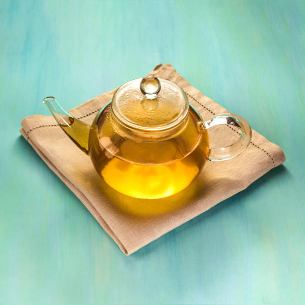 istock Square photo of teapot on teal texture with copyspace 656146372