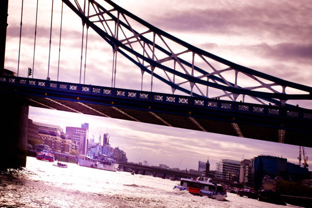 Tower Bridge at sunset Close up of Tower Bridge with a sunset sky behind and a cruise ship going through the bridge. the shard close up stock pictures, royalty-free photos & images