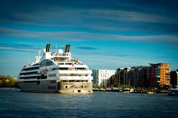 Cruise Ship on the Thames Cruise ship heading East and out to sea down the Thames near Tower Bridge. tower bridge london england bridge europe stock pictures, royalty-free photos & images