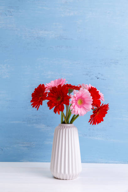 istock Gerbera flowers in vase on wooden background. 656146536