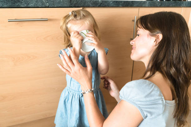 istock mom help the daughter to drink 656152126