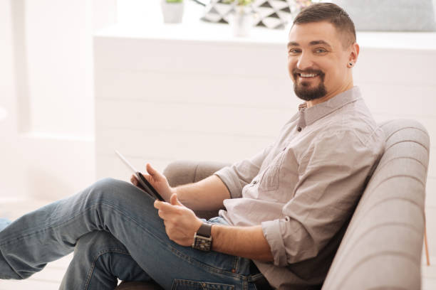 istock Happy bearded man surfing on the Internet 656158980