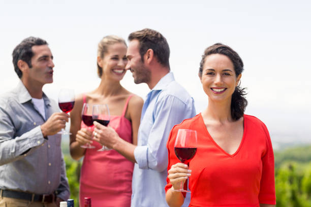 istock Woman holding wine glass smiling at camera 656159432