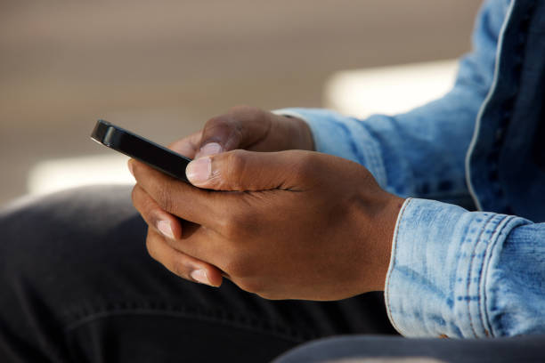 istock African male hands holding mobile phone 656164640