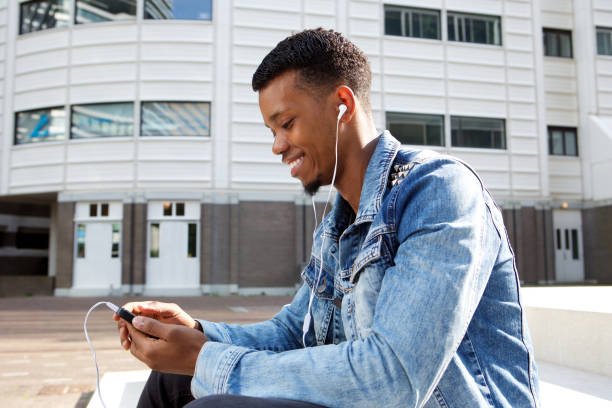 istock handsome african man with smart phone and headphones 656164658