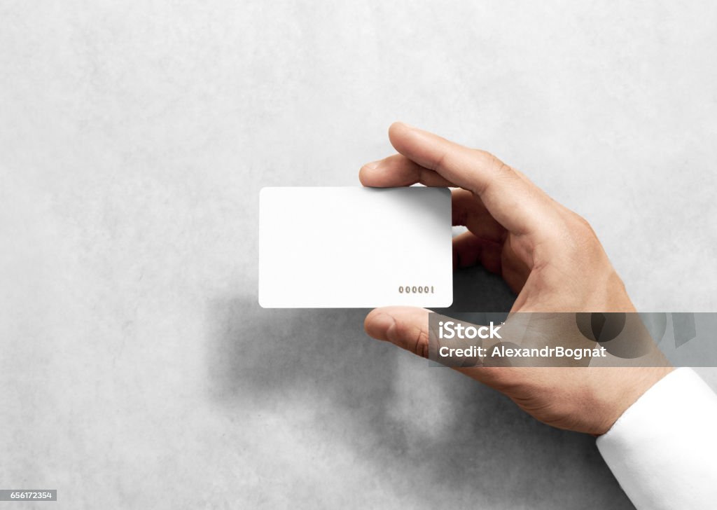 Hand hold blank white loyalty card mockup with rounded corners Hand hold blank white loyalty card mockup with rounded corners. Plain vip mock up template holding arm. Plastic discount namecard display front. Gift offset card design. Loyal service branding. Playing Card Stock Photo