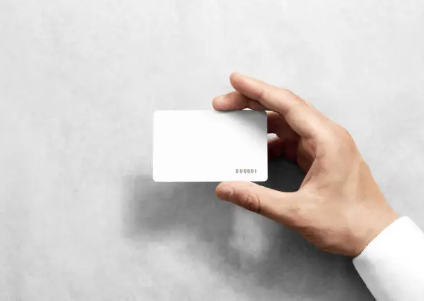 Photo of Hand hold blank white loyalty card mockup with rounded corners