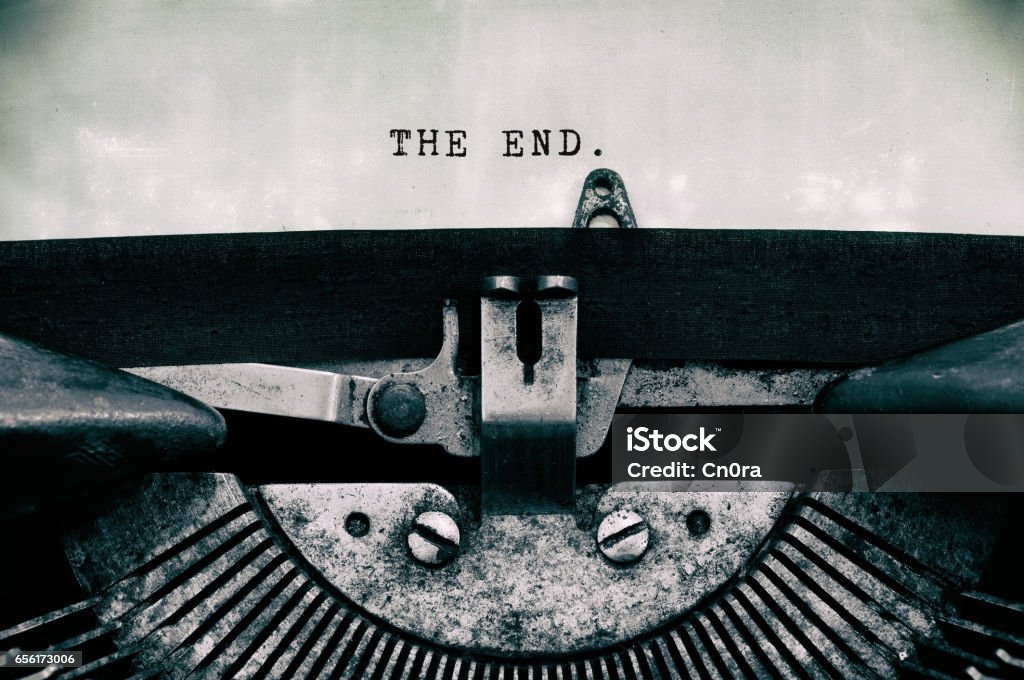 The end words typed on a vintage typewriter The end words typed on a vintage typewriter in black and white. Movie Stock Photo