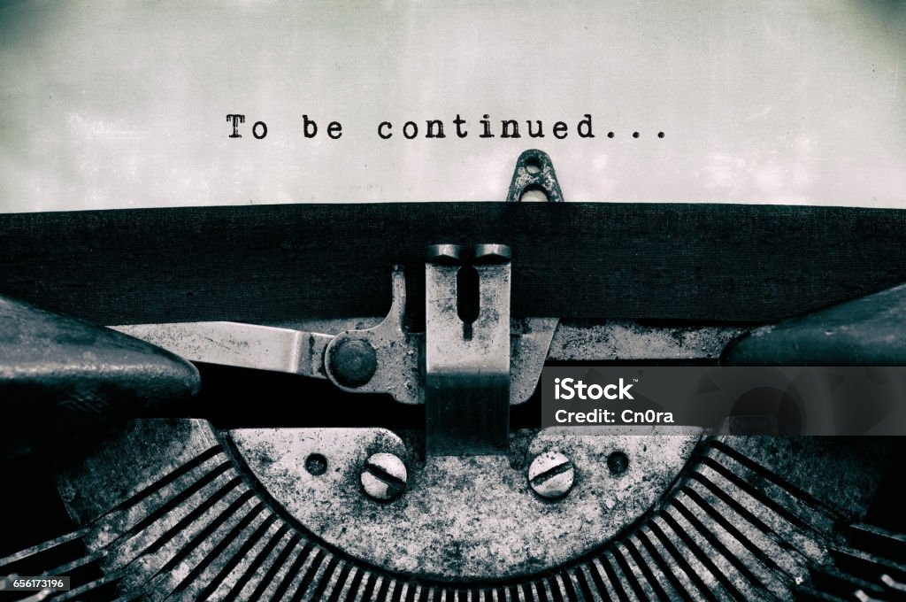 To be continued words typed on a vintage typewriter To be continued words typed on a vintage typewriter in black and white. Typewriter Stock Photo