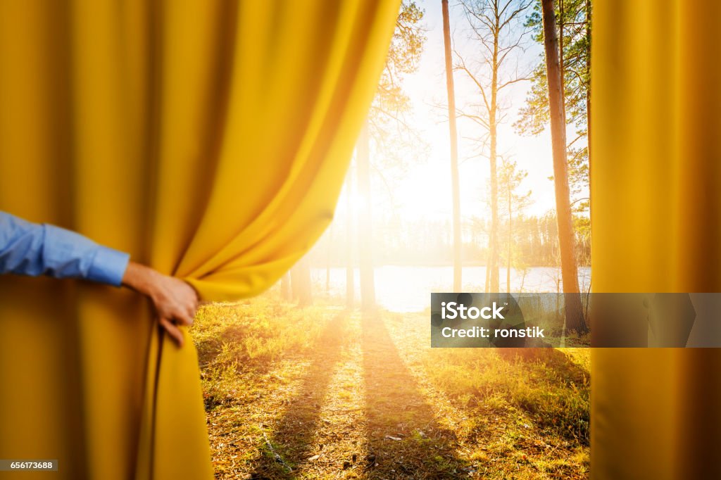 hand open curtain - concept of change and reveal new better world Curtain Stock Photo