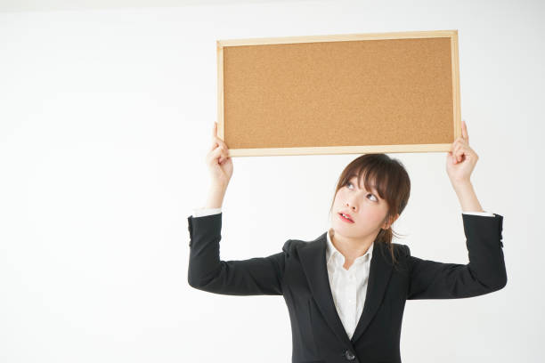 istock Young business woman holding board 656178884