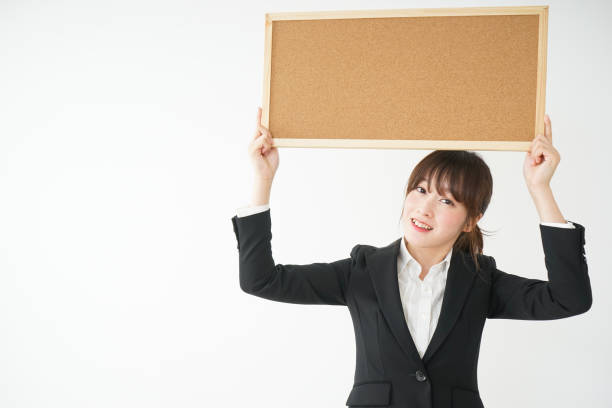 istock Young business woman holding board 656178900