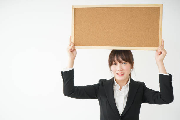 istock Young business woman holding board 656178922