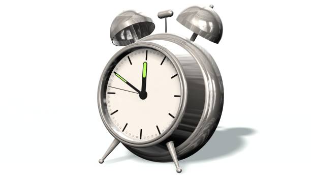 istock 10 before 12 - Retro alarm clock showing the time ten before twelve - isolated on white 656180756