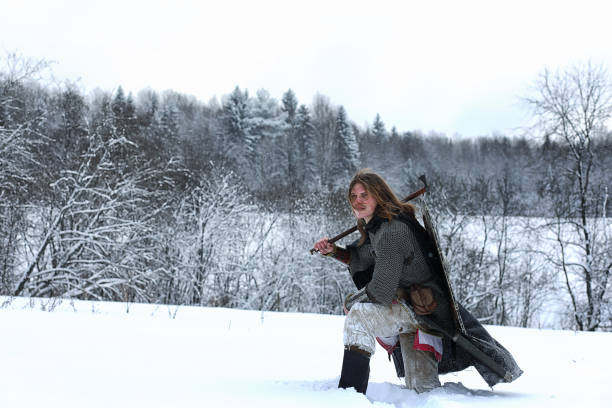 istock Defender the young warrior in mail armor armed with a sword 656181172
