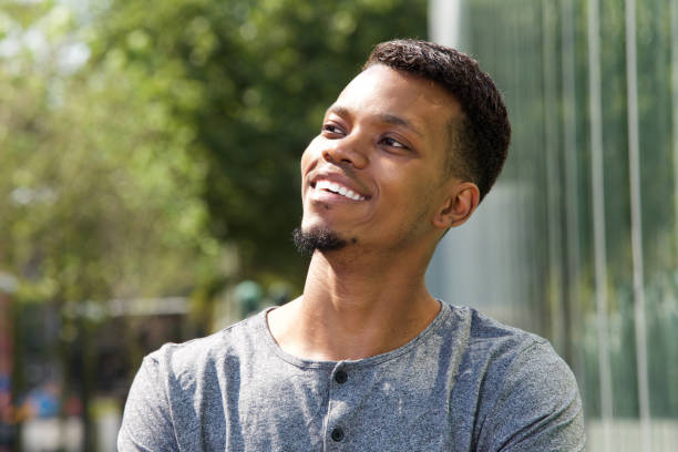 istock young african american man smiling outside 656183840