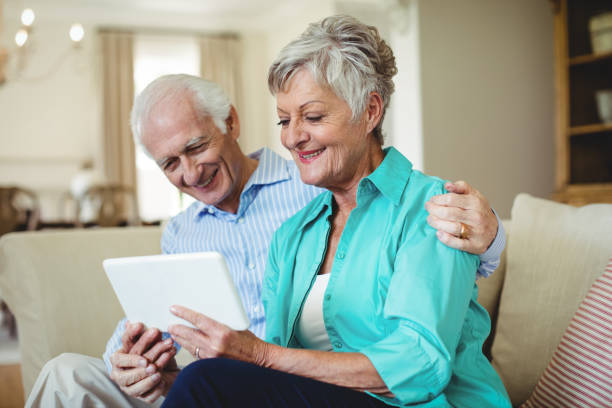 istock Senior couple using digital tablet in living room 656187948