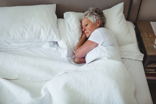 istock Senior woman sleeping on bed in bedroom 656188050