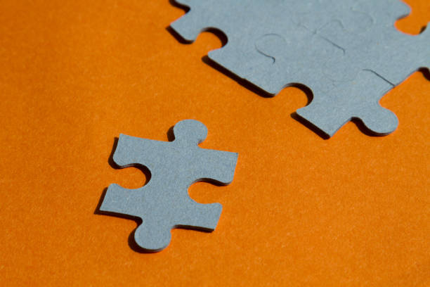 istock Jigsaw puzzle pieces on bright orange background, horizontal 656188594