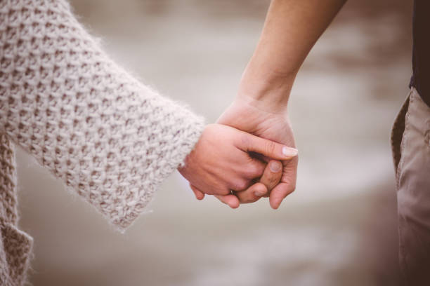 istock Romantic couple tenderly holding hands outdoors 656189652