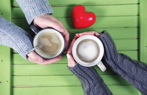 istock Couple drinking hot coffee at wooden table on a date 656192280