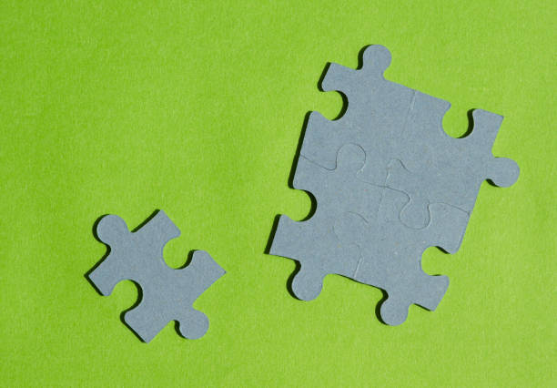 White jigsaw puzzle piece on the blue background. Horizontal composition with enough copy space for your text.