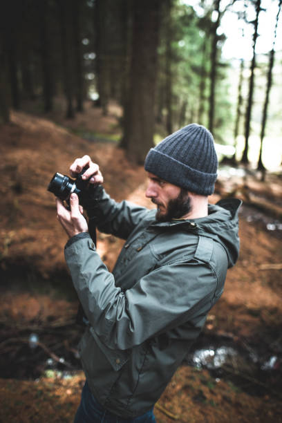 istock photographer hiking in the forest 656193228