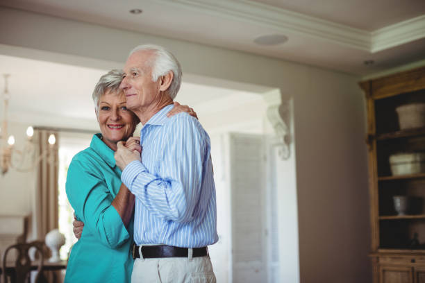 istock Senior couple dancing together in living room 656201024